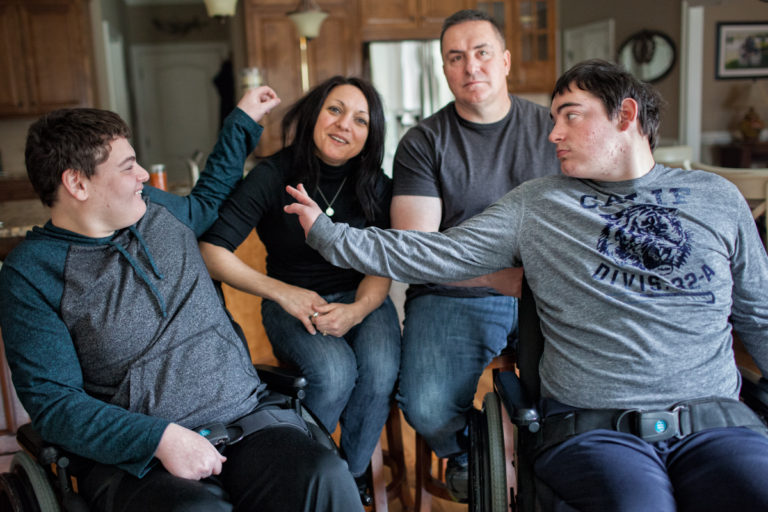 “My name is Diane and my husband is Pat. Together we have two boys, Aaron (on left) and Ryan (on right). Aaron is 21 and Ryan is 19. Both boys have been diagnosed with cerebral palsy, an intellectual disability and a seizure disorder. Ryan also has PDD (pervasive developmental disorder), a form of autism. In addition, they exhibit severe behaviors, including throwing, hitting, yelling and self‐injury. Neither Aaron or Ryan have ever received funding for support so Pat and I have been the sole care-givers for 21 years.  Both boys are on the short‐term waiting list for a Medicaid waiver.”

Diane and Pat
